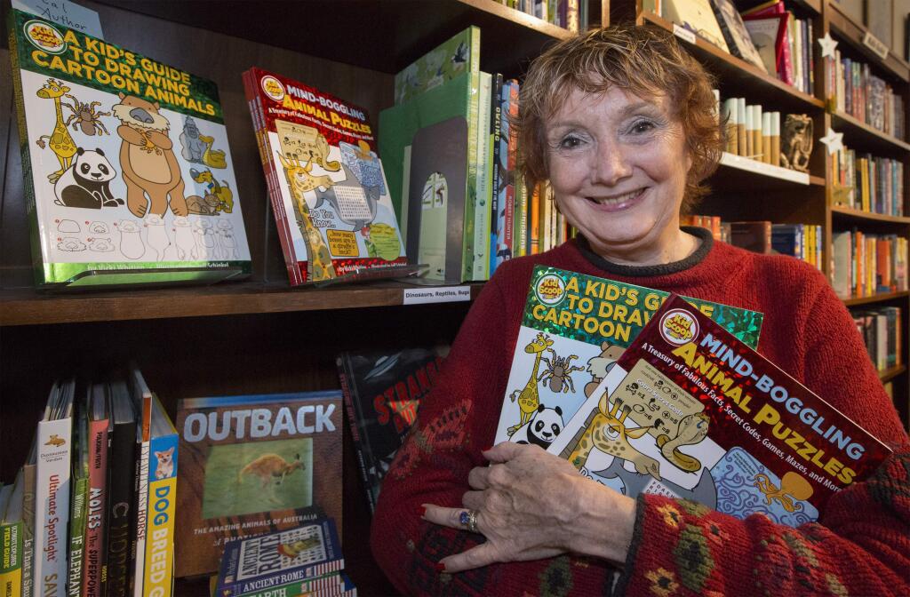 Vicki Whiting, known for her newspaper feature Kid Scoop, at Readers Books on Friday, Nov. 22, with her two new children's books 'A Kids Guide to Drawing Cartoon Animals' and 'Mind-Boggling Animal Puzzles'. (Photo by Robbi Pengelly/Index-Tribune)