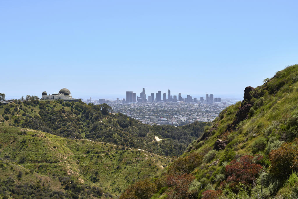 The Griffith Observatory and downtown Los Angeles are viewed under a blue sky as air pollution eased in the early weeks of the coronavirus pandemic. (PHILIP CHEUNG / New York Times, 2020)