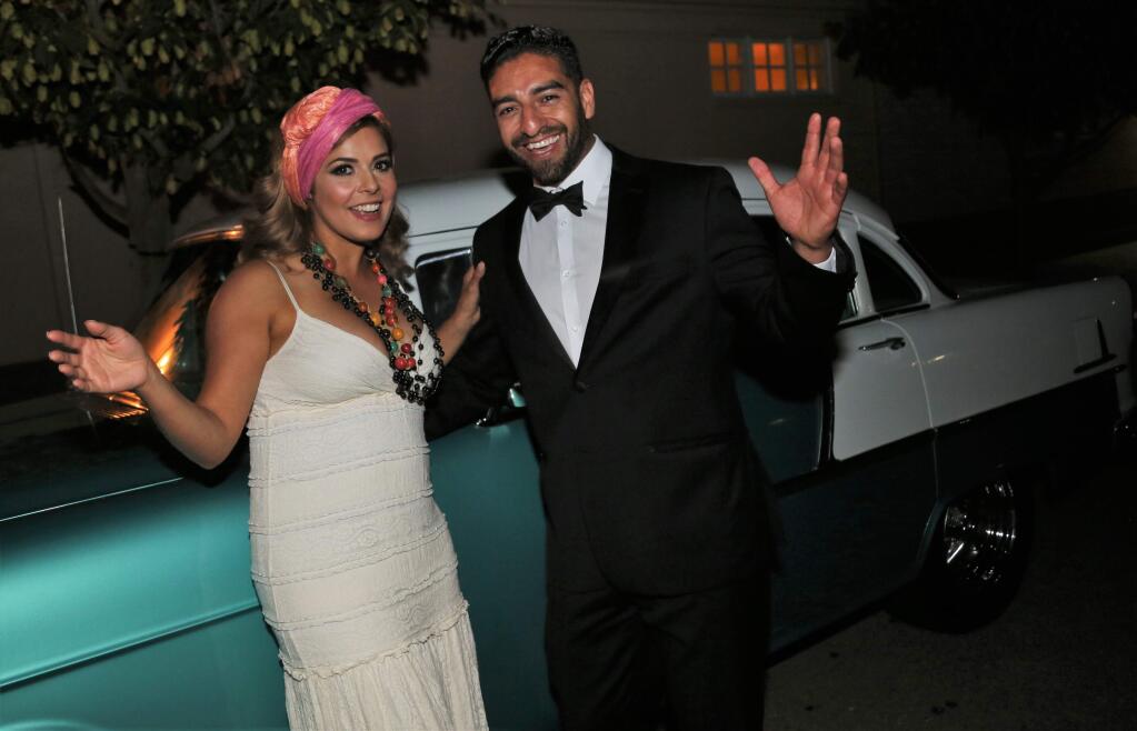 Yolanda Alvarez and Efren Carrillo pose for photos in front of one of the many 50's era cars at the Havana themed gala. Attendees enjoyed a fun filled evening of 1950's dress up, dancing, dinner, fine wine and casino games at the 4Cs Tuxedos and Tennis Shoes Goes to Havana Gala, Saturday, Sept. 9, 2017 at the Mary Agatha Furth Center in Windsor. The 4Cs marked its 45th year of improving the lives of local children through comprehensive child care and preschool services and programs. (Will Bucquoy / For the Press Democrat)
