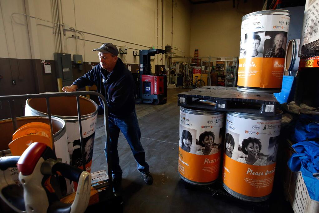 Duane Anderson loads empty donation barrels onto a pallet at the Redwood Empire Food Bank in Santa Rosa, California on Thursday, Dec. 21, 2017. (ALVIN JORNADA/ PD)
