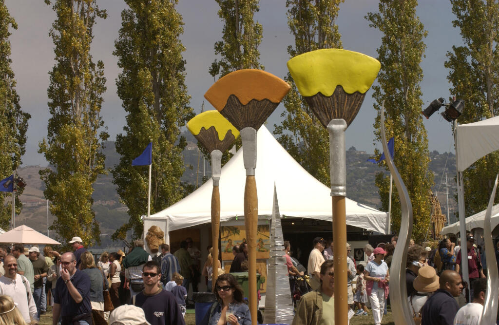 The crowd mingles among giant paint brushes at the Sausalito Art Festival. (The Press Democrat)