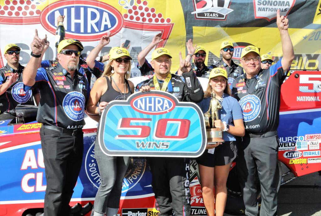 Last year's winners: Robert Hight and team pose for photos after winning the Funny Car Championship at the NHRA Sonoma Nationals at Sonoma Raceway on Sunday, July 28, 2019. There will be no NHRA races in Sonoma in 2020. (WILL BUCQUOY/ For The Press Democrat)