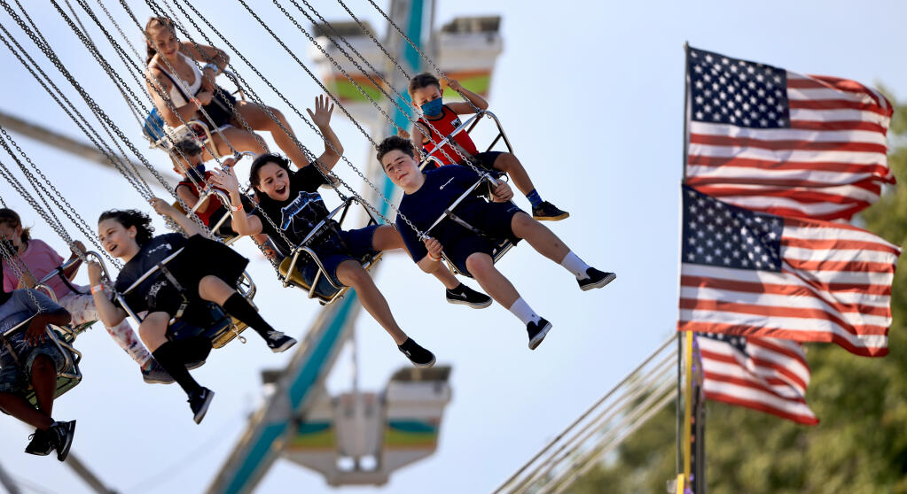 After a one year absence due to the pandemic, the Sonoma County Fair is back for a two-week appearance in Santa Rosa, Wednesday, July 28, 2021. The Wave Swinger is one of the main attractions, fair officials also moved the smaller kids carnival rides to the main midway.  (Kent Porter / The Press Democrat) 2021