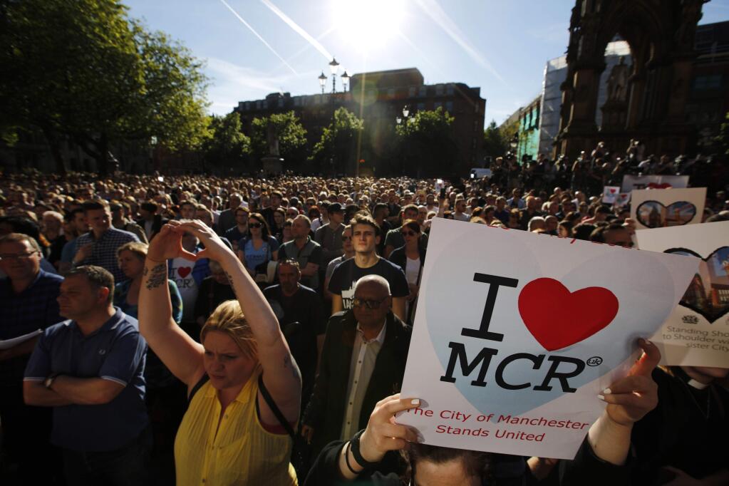 Crowds gather for a vigil in Albert Square, Manchester, England, Tuesday May 23, 2017, the day after the suicide attack at an Ariana Grande concert that left 22 people dead as it ended on Monday night. (AP Photo/Emilio Morenatti)