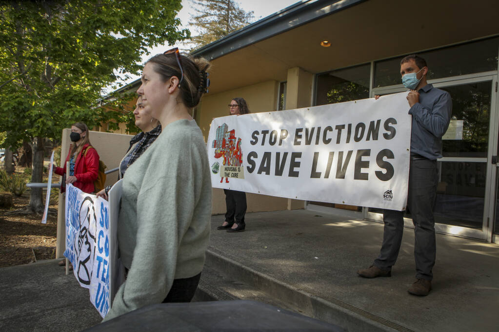 Several protestors stood outside of City Hall to express their concern over unfair evictions and affordable housing Monday, May 2, 2022. (CRISSY PASCUAL/ARGUS-COURIER STAFF)
