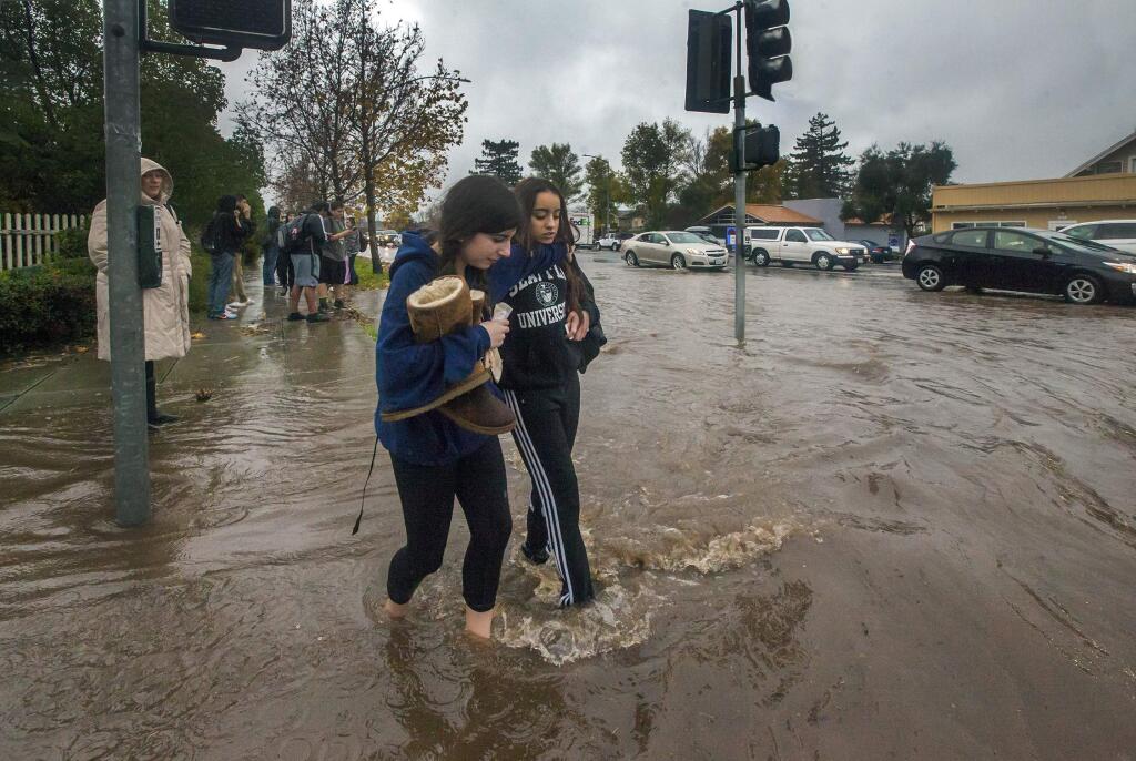 FILE - As the storm passed through the valley and city streets flooded, this was the scene at MacArthur and Broadway in Sonoma as high school students made their way home, January 2017. (Photo by Robbi Pengelly/Index-Tribune)