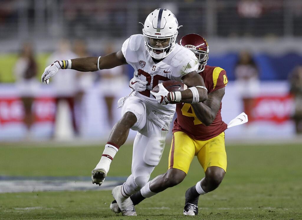Stanford running back Bryce Love (20) runs in front of USC safety Chris Hawkins (4) during the first half of the Pac-12 conference championship game in Santa Clara, Friday, Dec. 1, 2017. (AP Photo/Marcio Jose Sanchez)