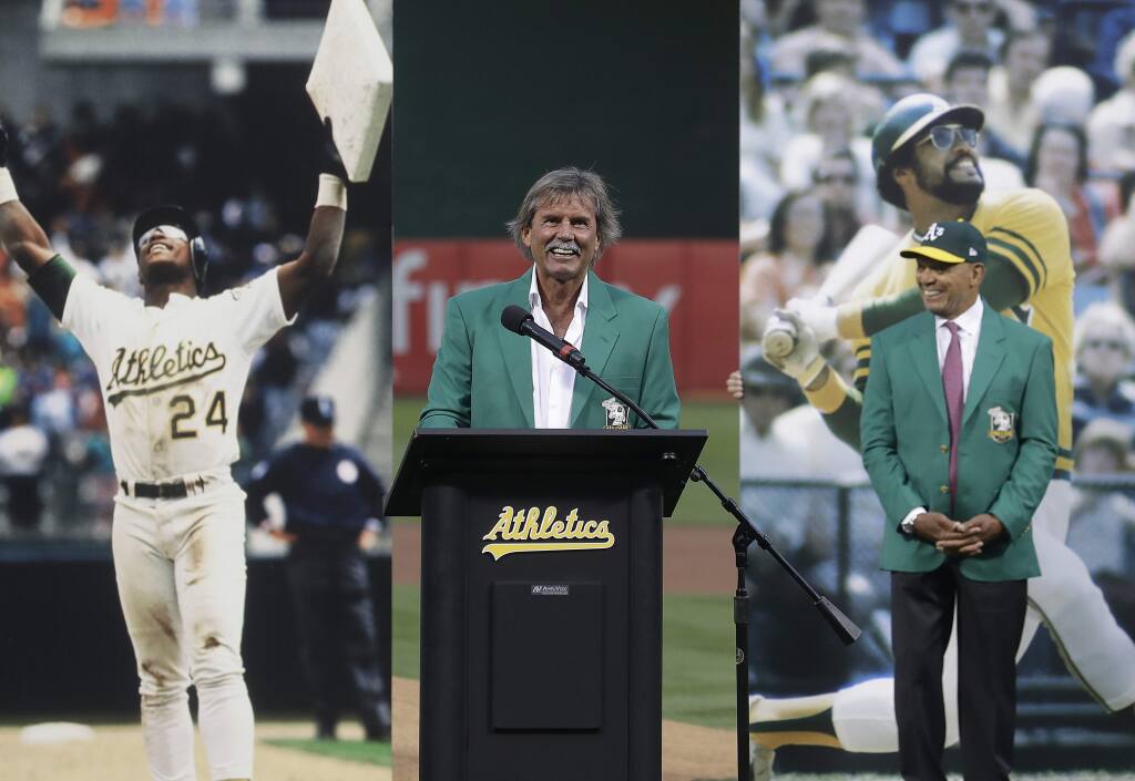 Former pitcher Dennis Eckersley, center, speaks during a ceremony inducting him into the Oakland Athletics' Hall of Fame before a baseball game between the Athletics and the New York Yankees in Oakland, Calif., Wednesday, Sept. 5, 2018. At right is Reggie Jackson. (AP Photo/Jeff Chiu)