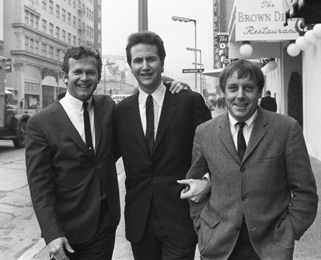 FILE - In this Jan. 31, 1967, file photo, members of the Kingston Trio, from left: Bob Shane, John Stewart and Nick Reynolds are pictured in the Hollywood section of Los Angeles. Shane, the last surviving original member of the popular folk group the Kingston Trio and the lead singer on its million-selling ballad “Tom Dooley” and many other hits, died Sunday, Jan. 26, 2020, in Phoenix. He was 85. (AP Photo/File)