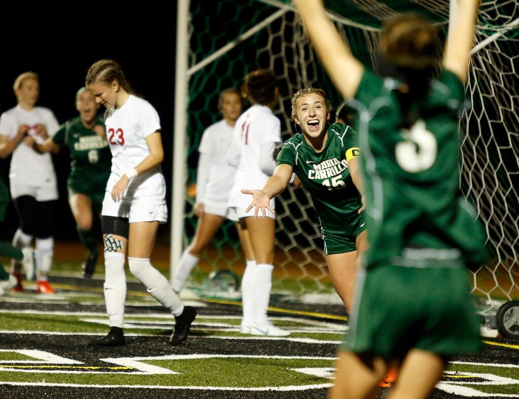 Maria Carrillo's Teagan Coleman (15) runs toward teammate Maddie Gmitter, right, in celebration after Gmitter's corner kick found the far corner of the goal, scoring a point for the Pumas during the first half between Montgomery and Maria Carrillo high schools, in Santa Rosa, on Tuesday, January 8, 2019. (Alvin Jornada / The Press Democrat)