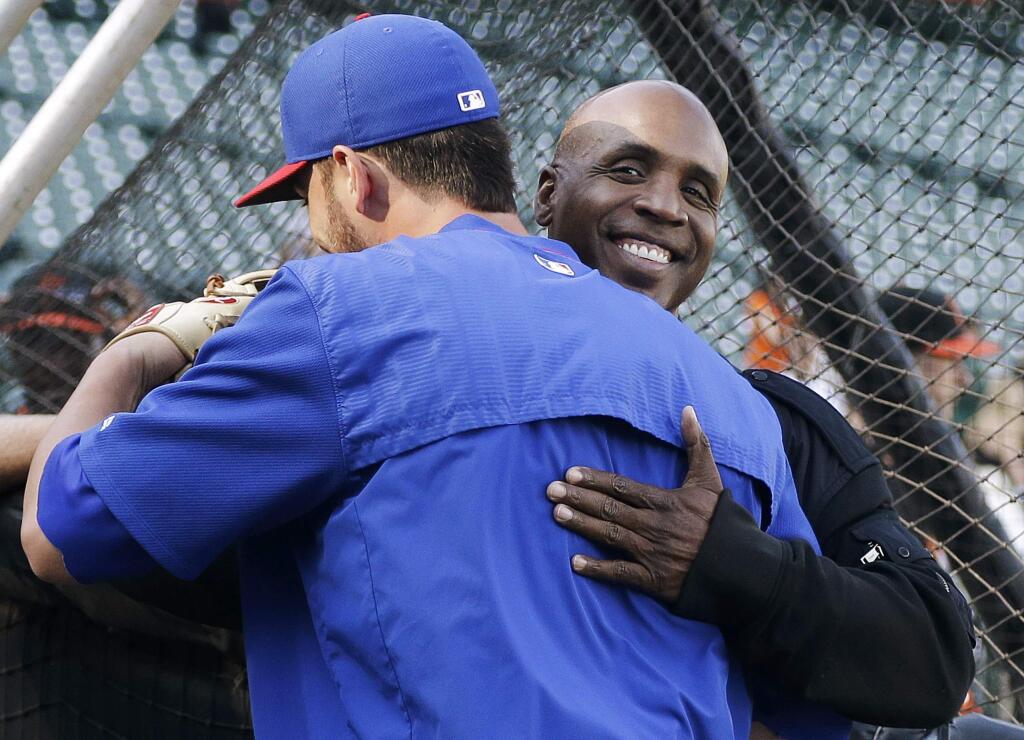 Chicago Cubs third baseman Kris Bryant, left, hugs former baseball player Barry Bonds before a baseball game between the San Francisco Giants and the Cubs in San Francisco, Tuesday, Aug. 25, 2015. (AP Photo/Jeff Chiu)
