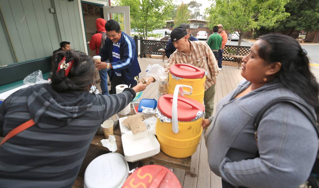 Maria Reyes, left, serves up food at the Graton Day Labor Center, Tuesday May 19, 2015 in Graton. (Kent Porter / Press Democrat) 2015