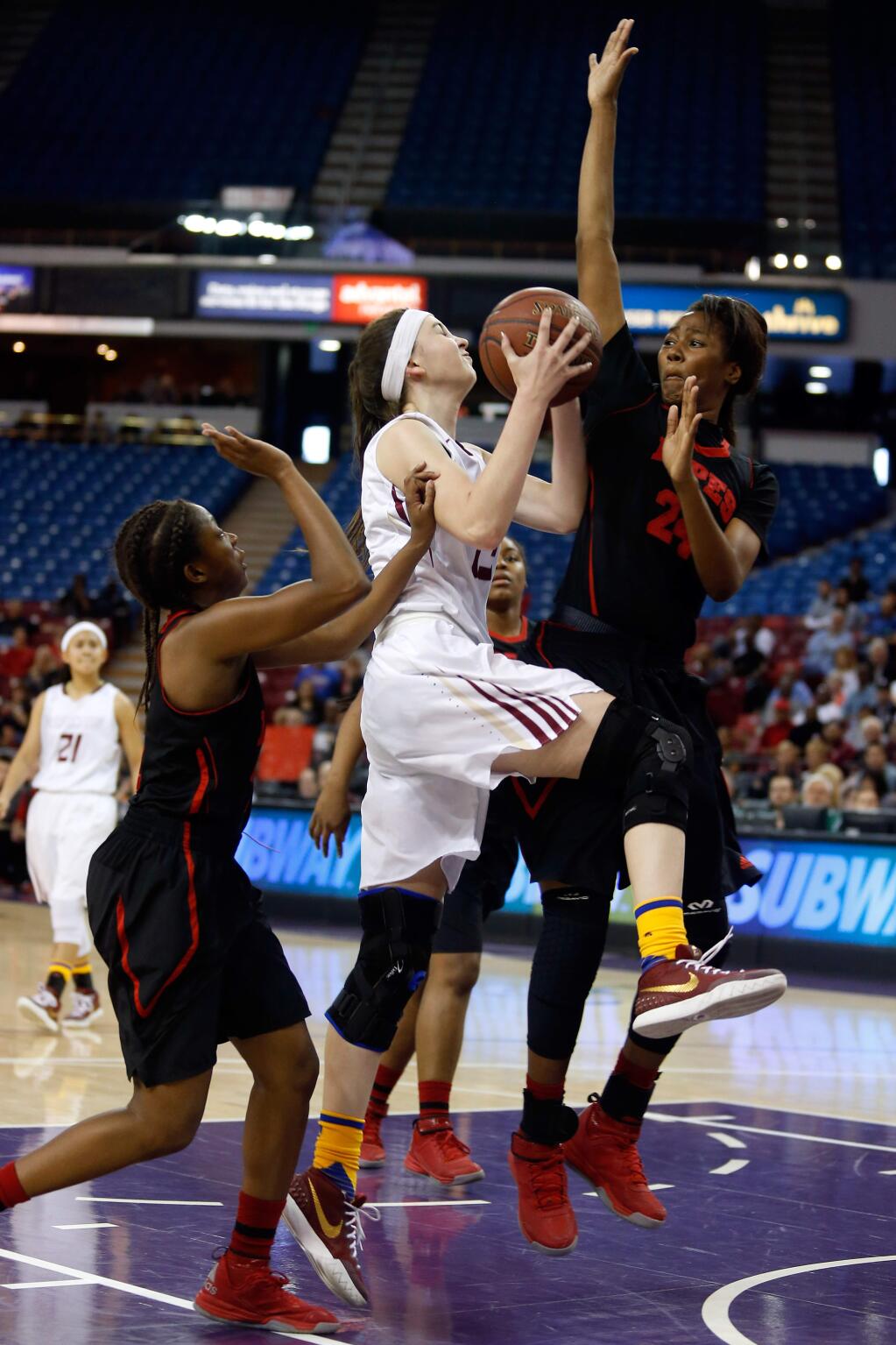 Cardinal Newman's Hailey Vice-Neat (13), center, drives to the basket and gets fouled by Antelope Valley's Oriana Brown (24), right, during the second half of the CIF Division IV girls basketball championship game between Cardinal Newman and Antelope Valley high schools at Sleep Train Arena in Sacramento, California, on Saturday, March 26, 2016. (Alvin Jornada / The Press Democrat)