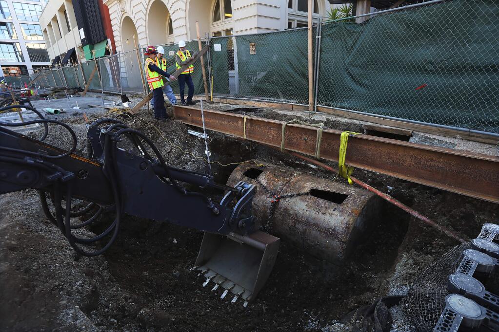 Workers remove a 2,500-gallon fuel tank found under Old Courthouse Square in Santa Rosa. The fuel in the tank was removed before the operation. (John Burgess/The Press Democrat)