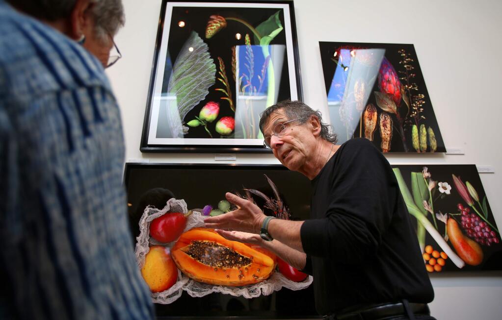 Artist Peter M. Krohn, right, talks with Judy Mathieson about his scanography of botanicals on aluminum in his studio, during the Sonoma County Art Trails Open Studio Tour, in Sebastopol on Sunday, October 12, 2014. (Christopher Chung/ The Press Democrat)
