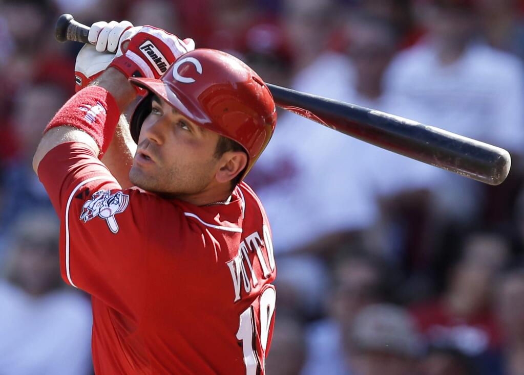 In this June 21, 2014, file photo, Cincinnati Reds' Joey Votto hits a double off Toronto Blue Jays starting pitcher J.A. Happ to drive in a run in the fourth inning of a baseball game in Cincinnati. (AP Photo/Al Behrman, File)