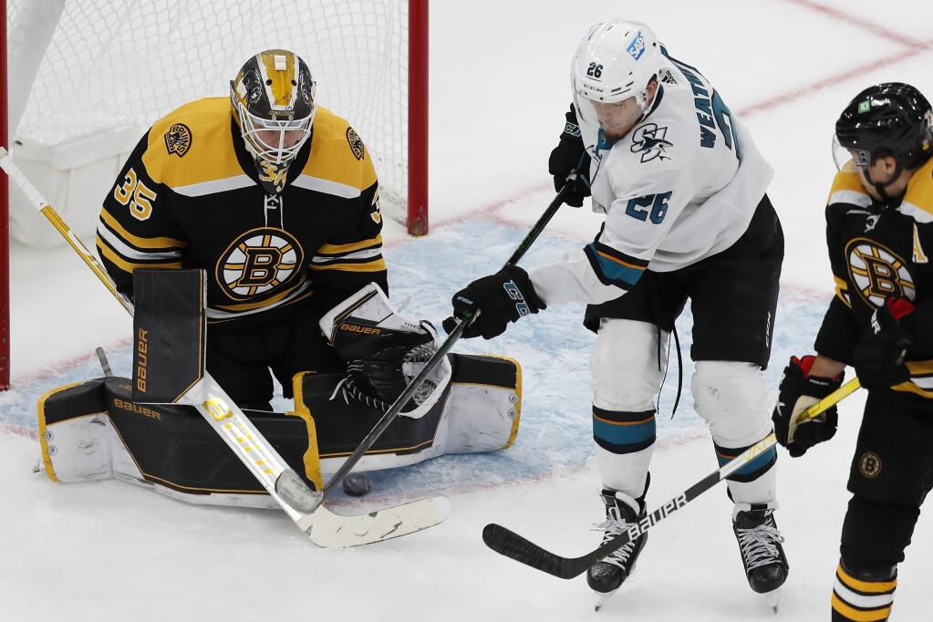 Boston Bruins' Linus Ullmark (35) blocks a shot in front of San Jose Sharks' Jasper Weatherby (26) during the third period of an NHL hockey game, Sunday, Oct. 24, 2021, in Boston. (AP Photo/Michael Dwyer)