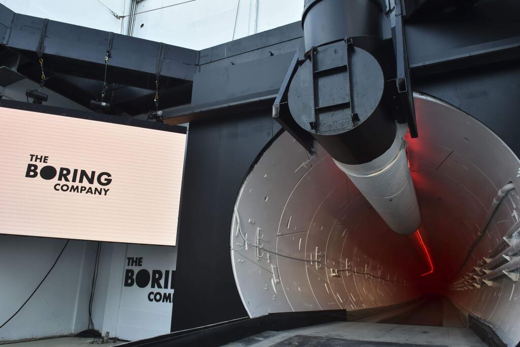 The Boring Co. signage is displayed at the tunnel entrance before an unveiling event for the Boring Co. Hawthorne test tunnel in Hawthorne, Calif., Tuesday, Dec. 18, 2018. Elon Musk unveiled his underground transportation tunnel on Tuesday, allowing reporters and invited guests to take some of the first rides in the revolutionary albeit bumpy subterranean tube - the tech entrepreneur's answer to what he calls 'soul-destroying traffic.' (Robyn Beck/Pool Photo via AP)