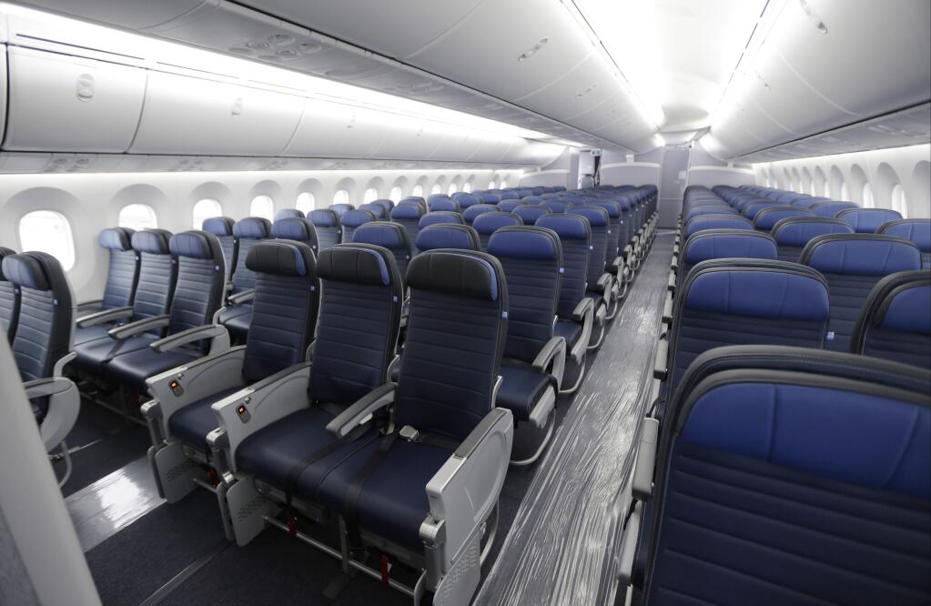 FILE - This Jan. 26, 2016, file photo, shows economy class seating on a new United Airlines Boeing 787-9 undergoing final configuration and maintenance work at Seattle-Tacoma International Airport in Seattle. United Airlines says it will raise the limit to $10,000 on payments to customers who give up seats on oversold flights and will increase training for employees as it deals with fallout from the video of a passenger being violently dragged from his seat. (AP Photo/Ted S. Warren, File)
