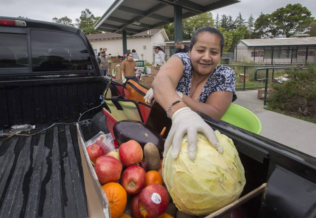 Denia Olea was one of many volunteers who distributed food from the Redwood Empire Food bank at the Flowery Elementary School in Boys Hot Springs on Monday, March 30. (Photo by Robbi Pengelly/Index-Tribune)