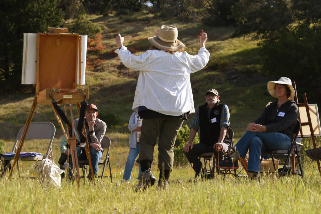 “I’ve taught ever age and I really enjoy awakening people,” said art professor Marsha Connell, center, with her students during “Painting through the Seasons,” a workshop held one day each season at Pepperwood Preserve in Santa Rosa on Saturday, April 2, 2022. (Erik Castro/for The Press Democrat)