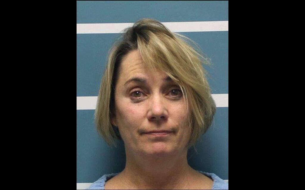 This Wednesday, Dec. 5, 2018, photo released by Tulare County Sheriff's Office shows Margaret Gieszinger, a high school teacher in central California who was arrested on suspicion of felony child endangerment,after forcibly cutting the hair of one of her students while singing the National Anthem, authorities said. Gieszinger was arrested Wednesday, after videos posted to social media showed a student at University Preparatory High School in the city Visalia sitting in a chair at the front of the classroom as Gieszinger cuts his hair. Gieszinger is being held on $100,000 bail. It was not immediately known if she has an attorney. (Tulare County Sheriff's Office via AP)
