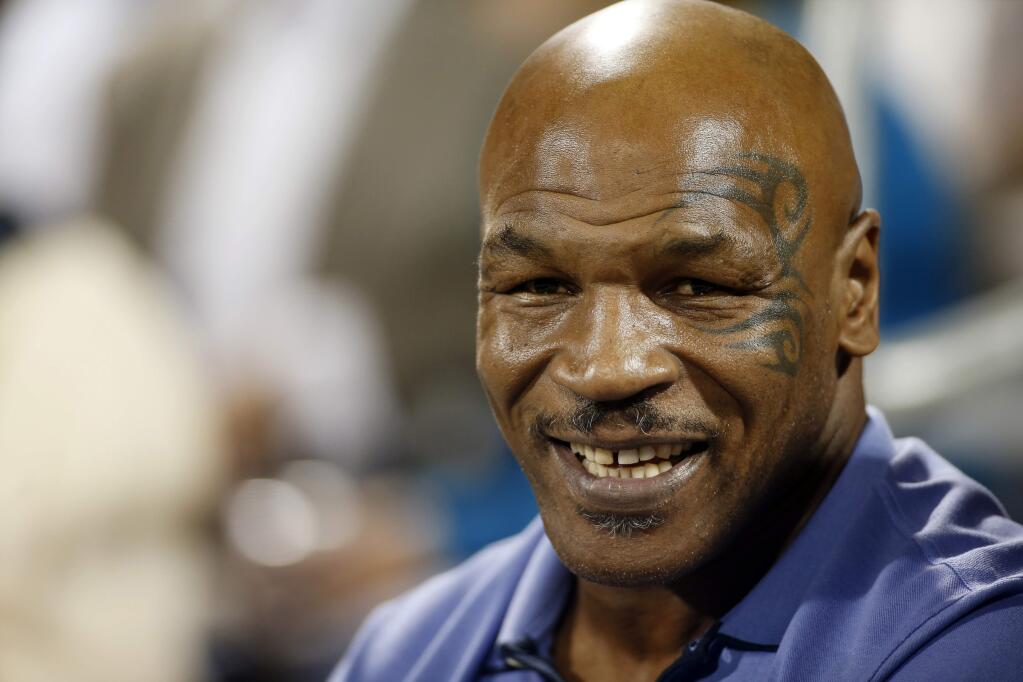 FILE - In this Monday, Oct. 10, 2016, file photo, Mike Tyson attends a World Team Tennis exhibition to benefit the Elton John AIDS Foundation in Las Vegas. The former heavyweight boxing champion is now focused on building a cannabis bud brand and resort center in the Mojave Desert. (AP Photo/Isaac Brekken, File)