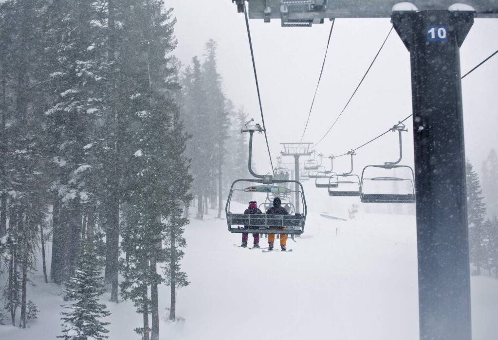 In this photo provided by Northstar California, skiers enjoy the view while riding on the Vista Express at the Northstar California resort in Truckee, Calif., Tuesday, Jan. 3, 2017. The Sierra Avalanche Center has issued an avalanche warning for the mountains around Lake Tahoe after a winter storm dumped nearly 2 feet of snow on area ski resorts. (Northstar California via AP)