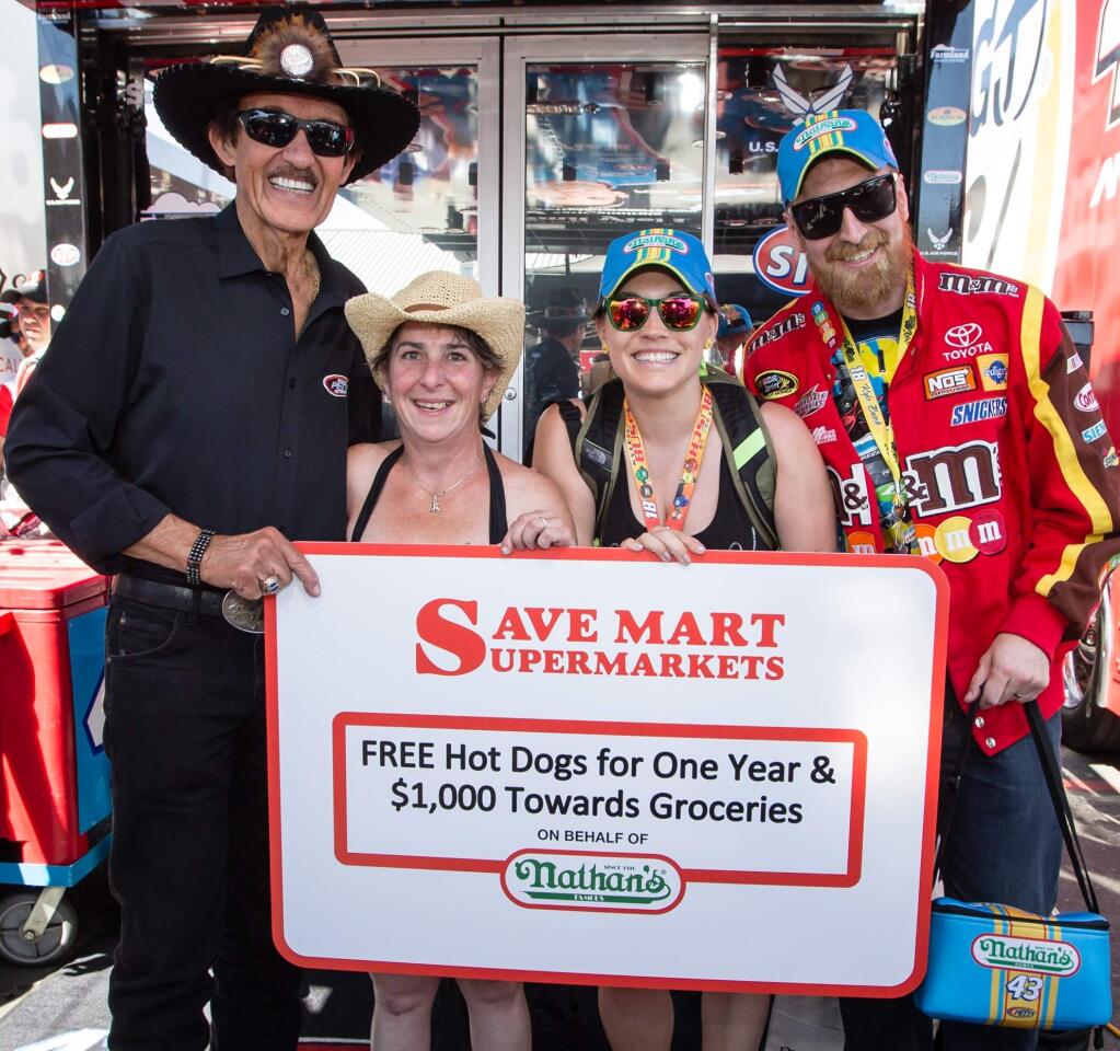 Sheana Davis, second from left, relishes her prize with race legend Richard Petty and friends in a celebration of all-things hot dog last month at Sonoma Raceway.