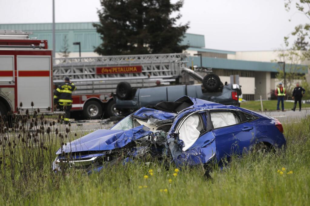 Petaluma police and fire crews respond to a fatal crash involing at least 6 vehicles on Lakeville Highway at the South McDowell Extention and Pine View Way in Petaluma on April 24. (BETH SCHLANKER / The Press Democrat)