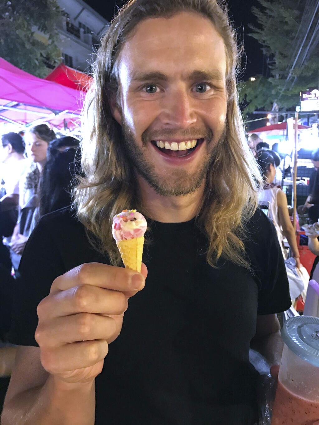 This photo taken Oct. 19, 2016, in Thailand, and provided by Lexi Abrams-Bourke shows Nick Walrath in the Chiang Mai Night Market. Walrath was listed as missing Monday, Dec. 5, 2016, in a deadly warehouse fire in Oakland, Calif. (Lexi Abrams-Bourke via AP)