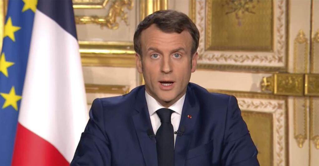 French President Emmanuel Macron gives a TV address to the nation announcing sweeping new measures to stem the spread of the new COVID-19 virus, saying people haven't complied with earlier public health measures and “we are at war”, in Paris Monday March 16, 2020. France is imposing nationwide restrictions on how far from their homes people can go, and for what purpose, as part of the country's strategy to stop the spread of the new coronavirus. For most people, the new coronavirus causes only mild or moderate symptoms, but for some it can cause more severe illness, especially in older adults and people with pre-existing health problems. (France Televisions via AP)