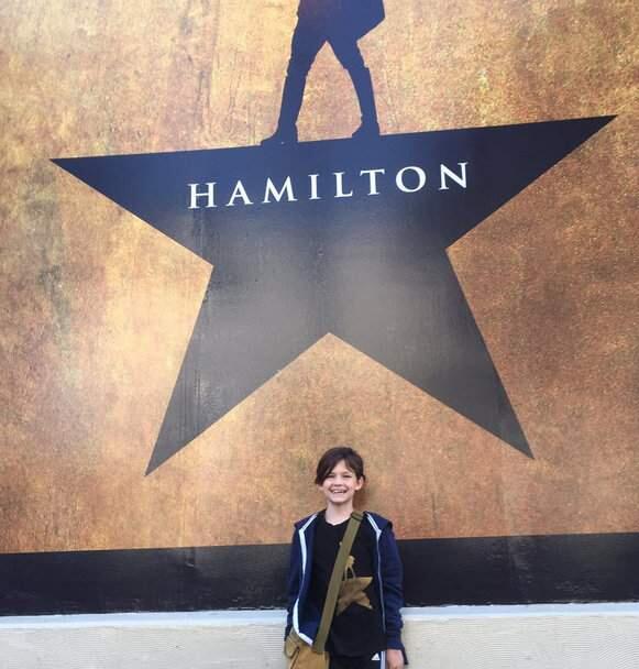 Lena Meline stands outside the Orpheum Theater in San Francisco before a 'Hamilton' show. The 9-year-old gave her ticket to a stranger before the show. (GABE MELINE/ TWITTER)
