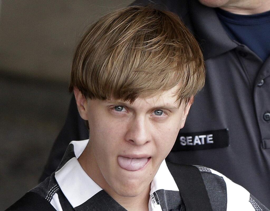 Charleston, S.C., shooting suspect Dylann Storm Roof is escorted from the Cleveland County Courthouse in Shelby, N.C., Thursday, June 18, 2015. Roof is a suspect in the shooting of several people Wednesday night at the historic The Emanuel African Methodist Episcopal Church in Charleston. (AP Photo/Chuck Burton)