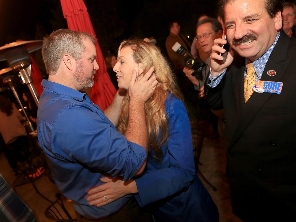 James Gore celebrates his victory with his wife Elizabeth in Healdsburg on Tuesday Nov. 4, 2014. At right is campaign supporter Anthony Geraldi. (KENT PORTER/ PD)