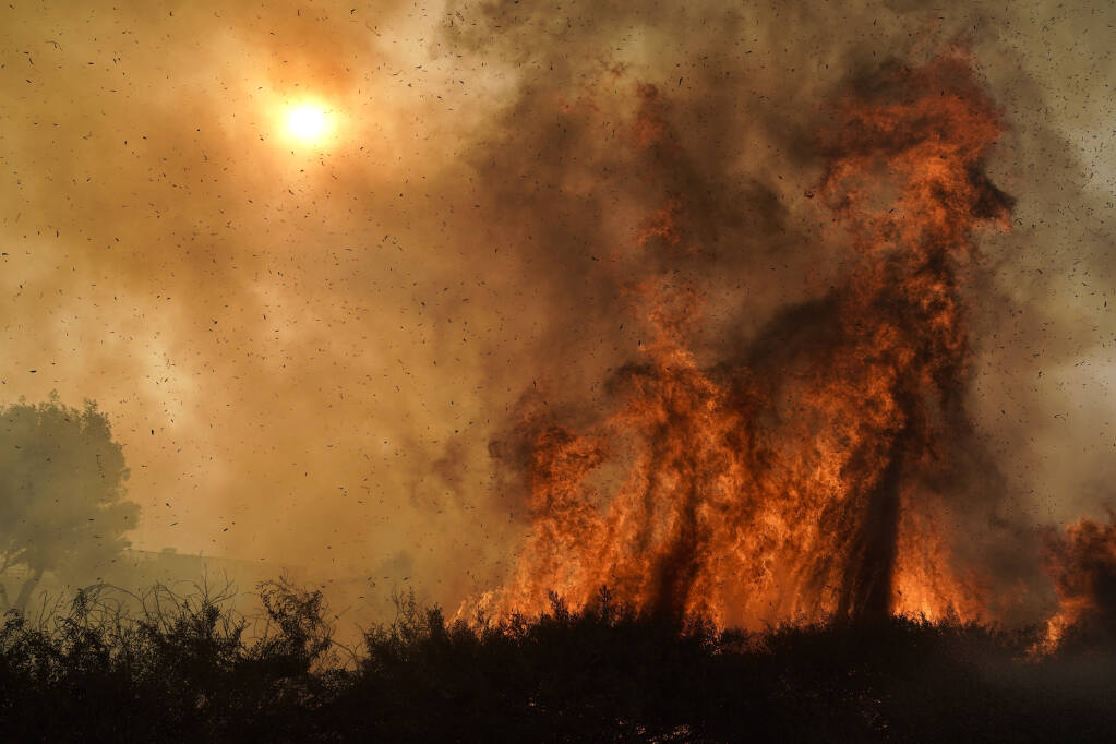 A group of scientists from universities, government and private industry is developing new tools for predicting the behavior of wildfires. (JAE C. HONG / Associated Press, 2020)