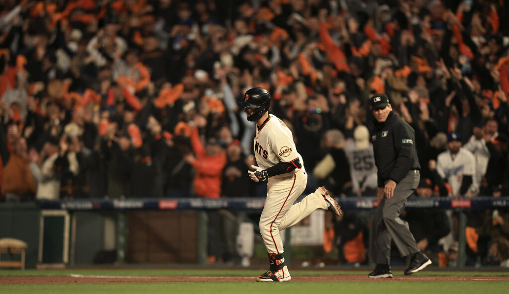 Buster Posey rounds first base after clubbing a two-run home run during Game 1 of the National League Division Series between San Francisco and Los Angeles on Friday, Oct. 10, 2021 in San Francisco. (Kent Porter / The Press Democrat)