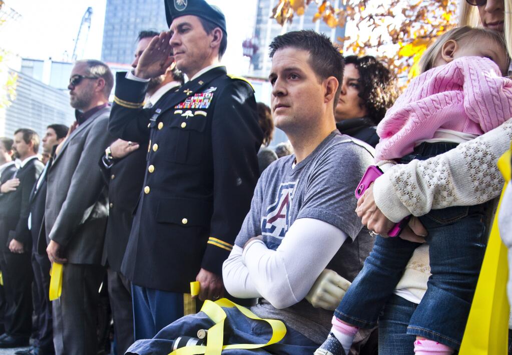 FILE - Former U.S. Air Force veteran and Iraq war double amputee Brian Kolfage, second from right, attends the National September 11 Memorial and Museum's "Salute to Service" tribute honoring U.S. veterans, Nov. 10, 2014 in New York. Kolfage, co-founder of the "We Build The Wall" project aimed at raising money for a border wall, has pleaded guilty, Thursday, April 21, 2022 to charges in a case that once included former President Donald Trump's adviser Steve Bannon. (AP Photo / Bebeto Matthews, File)