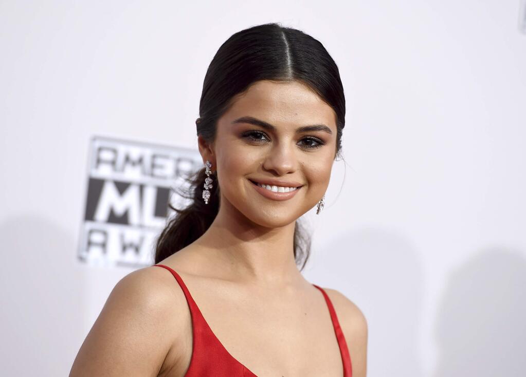 FILE - In this Nov. 20, 2016 file photo, Selena Gomez arrives at the American Music Awards in Los Angeles. Instagram released its year-end data Thursday, Dec. 1, showing the pop star has the most followers of any celebrity (103 million) and was responsible for nearly all of the most-liked celebrity posts in 2016. (Photo by Jordan Strauss/Invision/AP, File)