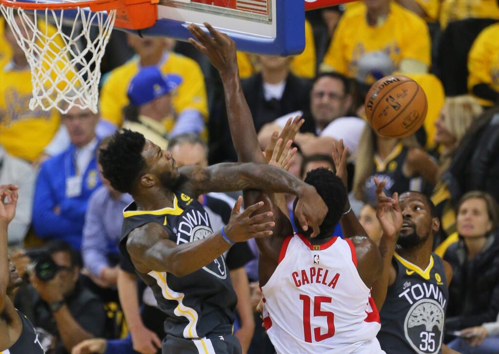 Golden State Warriors center Jordan Bell rejects a shot attempt by Houston Rockets center Clint Capela, during Game 4 of the Western Conference Finals in Oakland on Tuesday, May 22, 2018. (Christopher Chung / The Press Democrat)