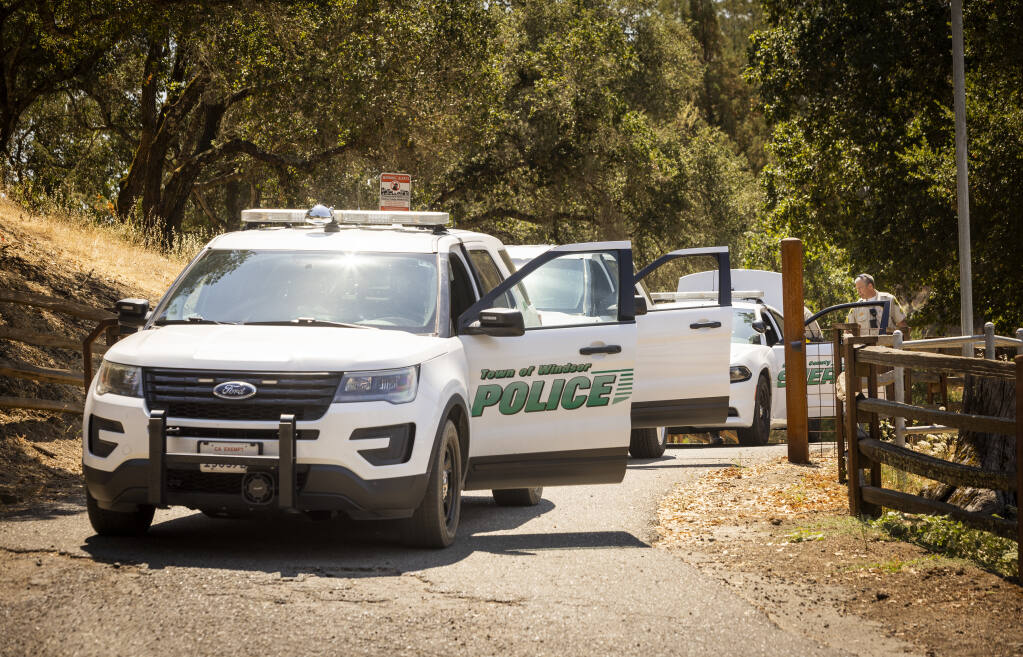 Windsor Police and Sonoma County Sheriff vehicles leave the site of a fatal shooting north of Windsor on Friday, July 29, 2022. Officials say a Sonoma County sheriff's deputy fatally shot someone.  (John Burgess/The Press Democrat)