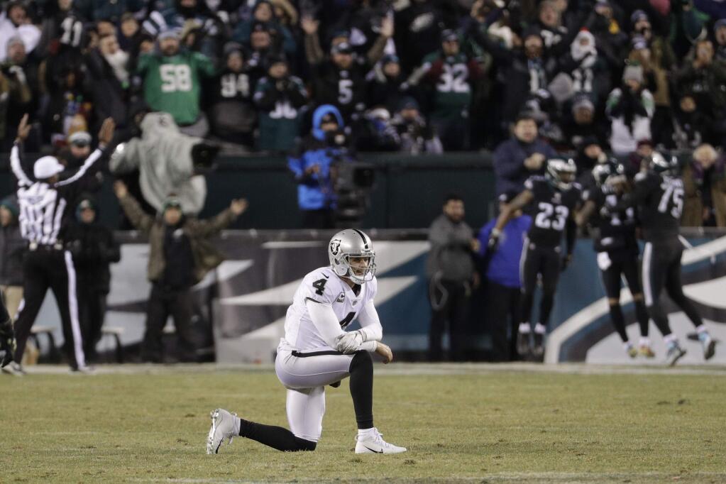 The Oakland Raiders' Derek Carr reacts after throwing an interception during the second half against the Philadelphia Eagles, Monday, Dec. 25, 2017, in Philadelphia. (AP Photo/Chris Szagola)