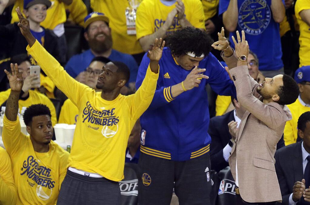 Golden State Warriors' Brandon Rush, Ian Clark, Anderson Varejao and Stephen Curry, from left, celebrate a score against the Houston Rockets during the first half in Game 5 of a first-round NBA basketball playoff series Wednesday, April 27, 2016, in Oakland, Calif. (AP Photo/Ben Margot)