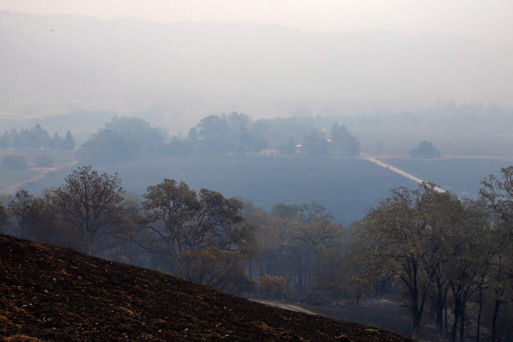 A thick layer of smoke settles over West Road in Redwood Valley, California on Monday, October 9, 2017. According to reports, some residents who were unable to evacuate in time along West and Tomki Roads succumbed to the fast-moving fire. (Alvin Jornada / The Press Democrat)