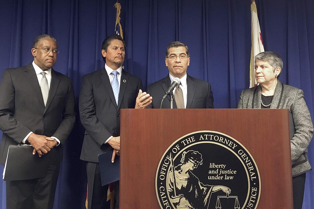 California Attorney General Xavier Becerra, at podium, is joined by, from left, Loren J. Blanchard, California State University Executive Vice Chancellor for Academic and Student Affairs; Eloy Ortiz Oakley, California Community Colleges Chancellor; and Janet Napolitano, University of California President at a news conference in Sacramento. Becerra is concerned about open-ended immigration sweeps as he and other California officials say the Trump administration should concentrate on deporting dangerous felons. Immigration officials declined to comment on any specific operations, but Democratic U.S. Sens. Dianne Feinstein and Kamala Harris asked for details and called raids punishing Californians 'an abhorrent abuse of power' and waste of resources. (AP Photo/Don Thompson)
