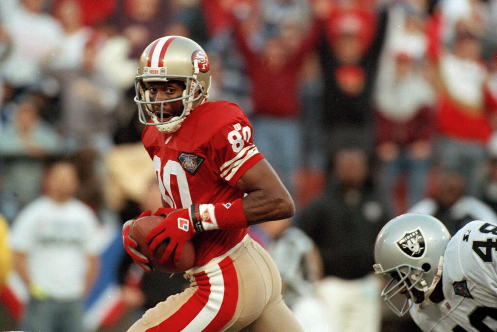 San Francisco 49ers wide receiver Jerry Rice, left, runs with the ball past Los Angeles Raiders cornerback Lionel Washington to score his 125th career touchdown during the first quarter at Candlestick Park in San Francisco on Sept. 5, 1994. (AP Photo/George Nikitin)