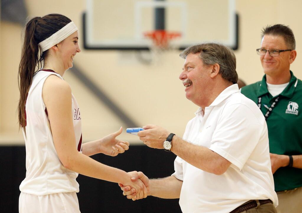 Cardinal Newman's Hailey Vice-Neat (13) receives her championship medal from principal Graham Rutherford after the Cardinals defeated Menlo School with a score of 51-32 in the CIF NorCal Division 4 girls basketball championship game in American Canyon, California on Saturday, March 19, 2016. (Alvin Jornada / The Press Democrat)