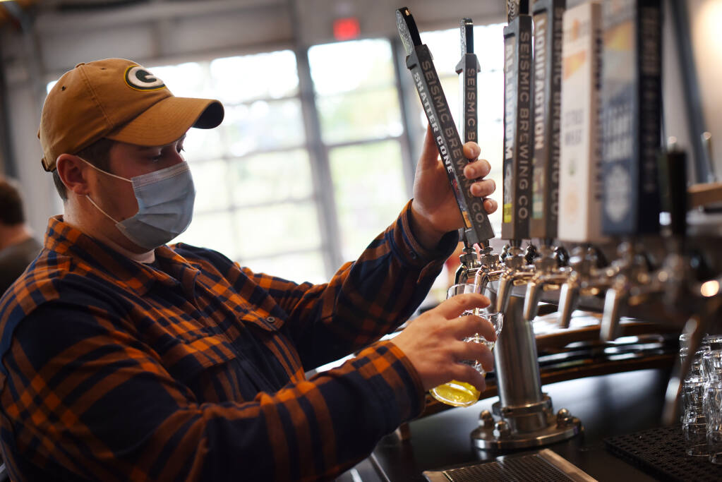 Korey Smith pours an IPA at Seismic Brewing Taproom in The Barlow in Sebastopol on Thursday, Oct. 7, 2021. (Erik Castro/for The Press Democrat)