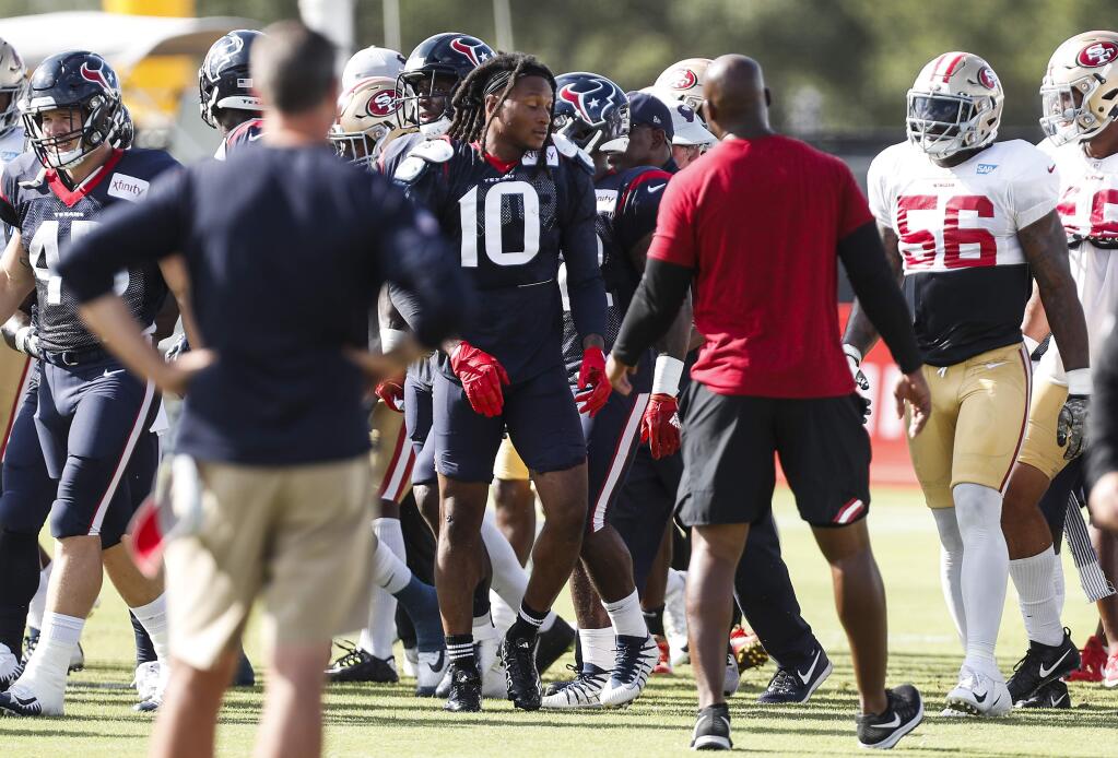 Houston Texans wide receiver DeAndre Hopkins, center, emerges from an altercation with San Francisco 49ers defensive back Jimmie Ward, not shown, during a joint practice in Houston, Wednesday, Aug. 15, 2018. (Brett Coomer/Houston Chronicle via AP)