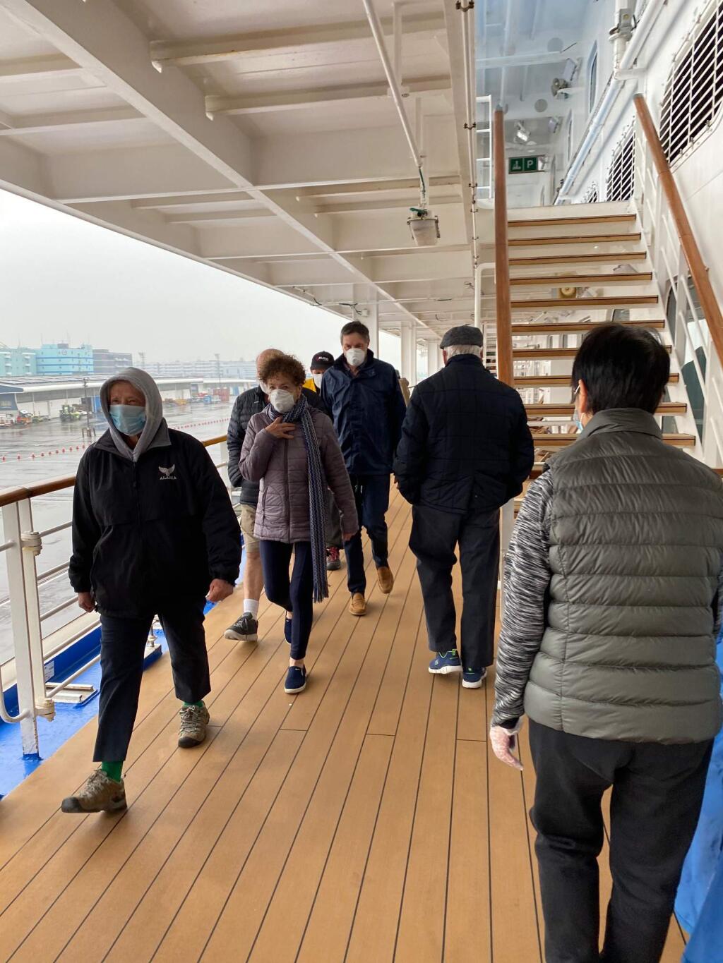 Diamond Princess passengers enjoy their supervised walks on the quarantined ship. (Saber family)